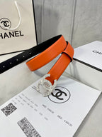Chanel orange belt with crystal buckle and adjustable holes over black lining