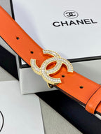 Crystal CC buckle on Chanel orange belt with black-lined strap
