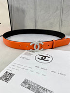 Chanel orange belt with black underside and crystal CC buckle, adjustable holes