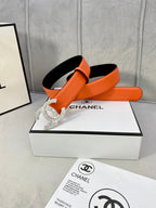 Chanel orange belt with crystal CC buckle, shown with black-lined side