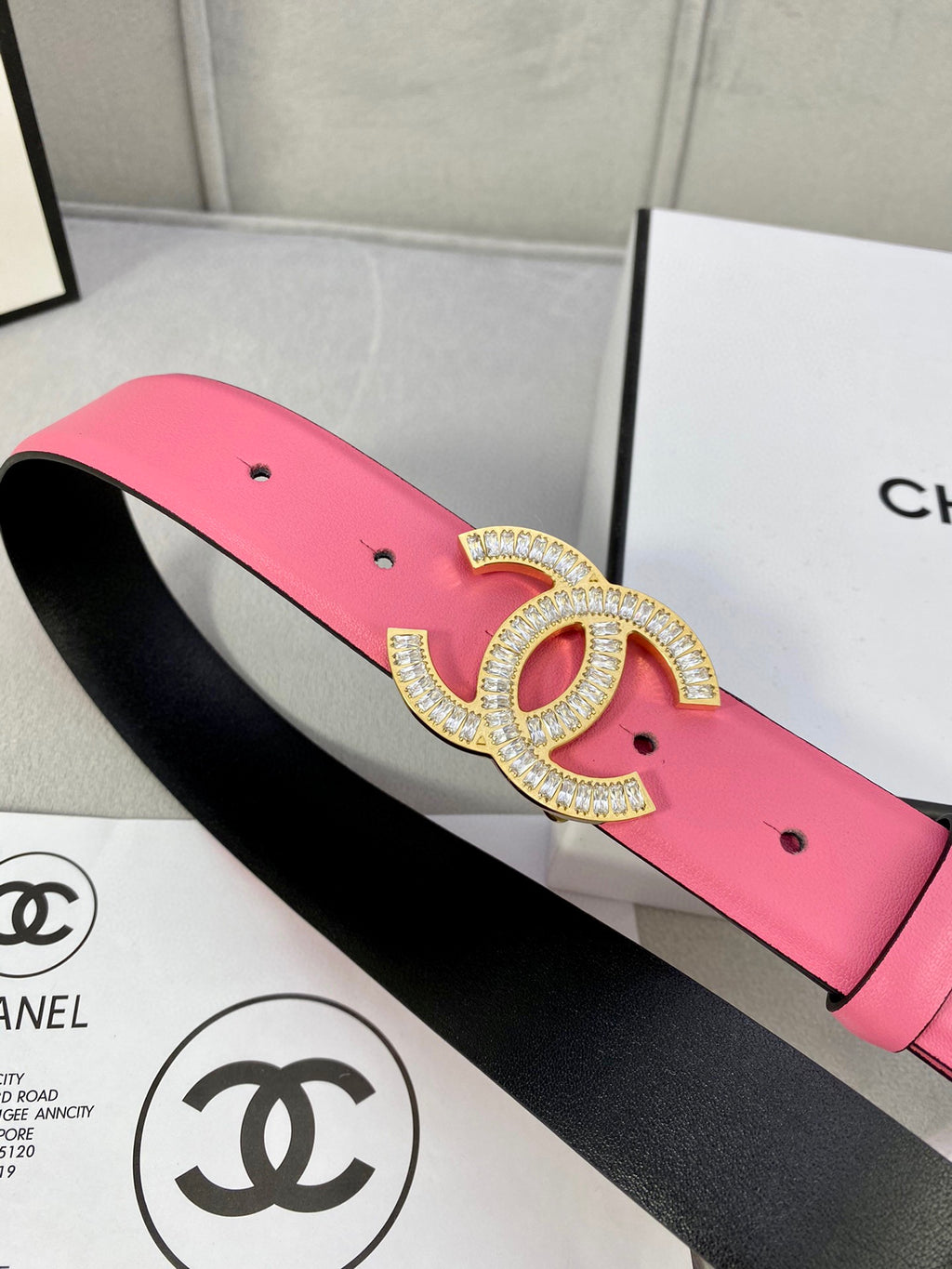 Chanel belt with pink leather and rhinestone CC buckle on black-lined strap