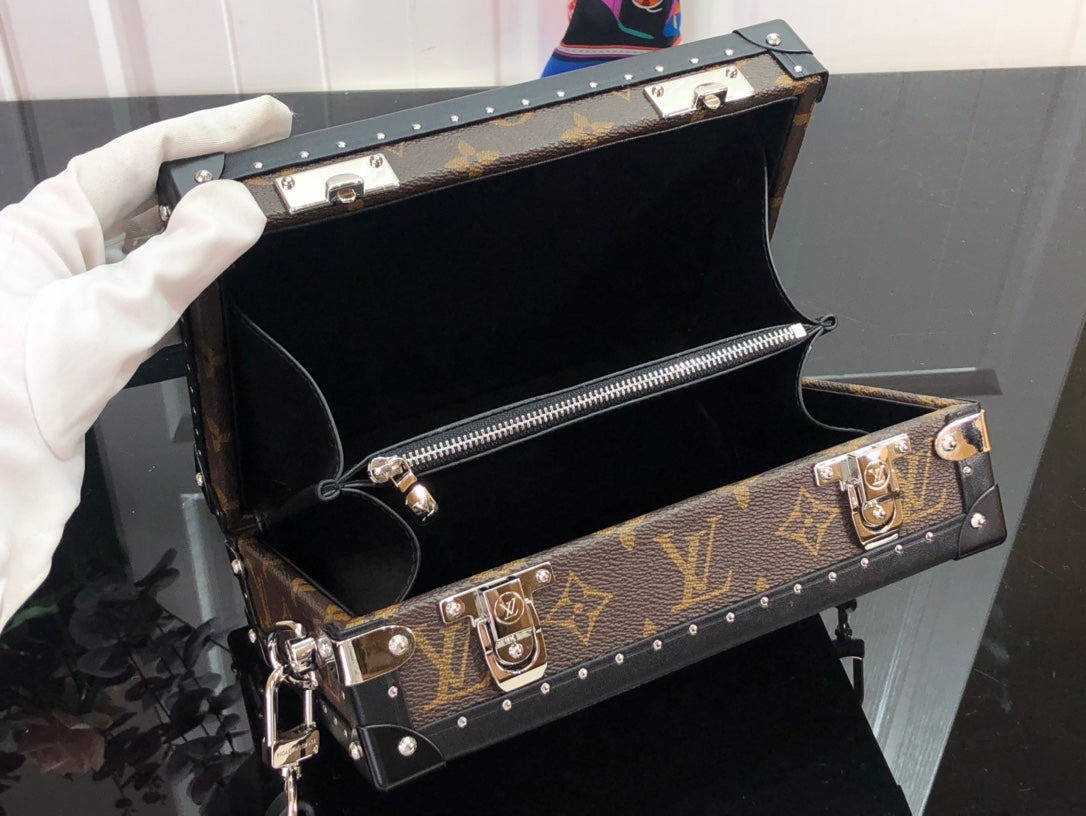 Louis Vuitton bag open view with monogram canvas sides, studded trim, and zipper pocket
