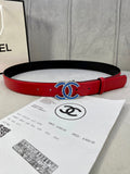 Red and black Chanel belt with blue-and-gold CC logo buckle and metal pin holes