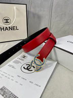 Red leather belt with blue-and-gold CC logo buckle and pin-hole strap on papers