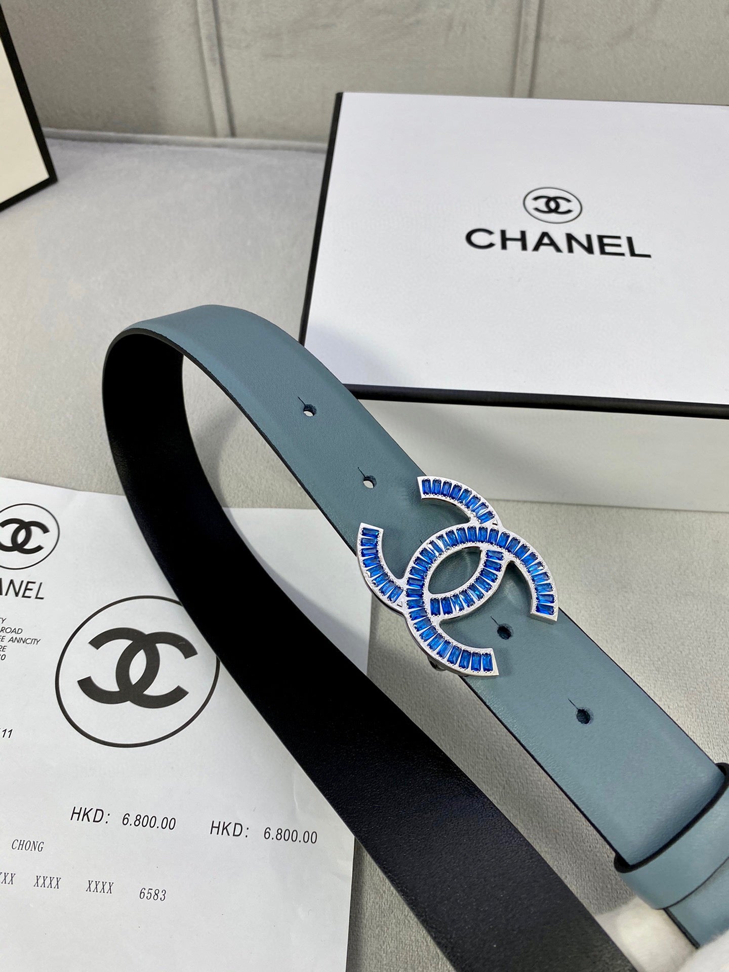 Chanel belt with light blue strap and CC logo buckle, loop close view