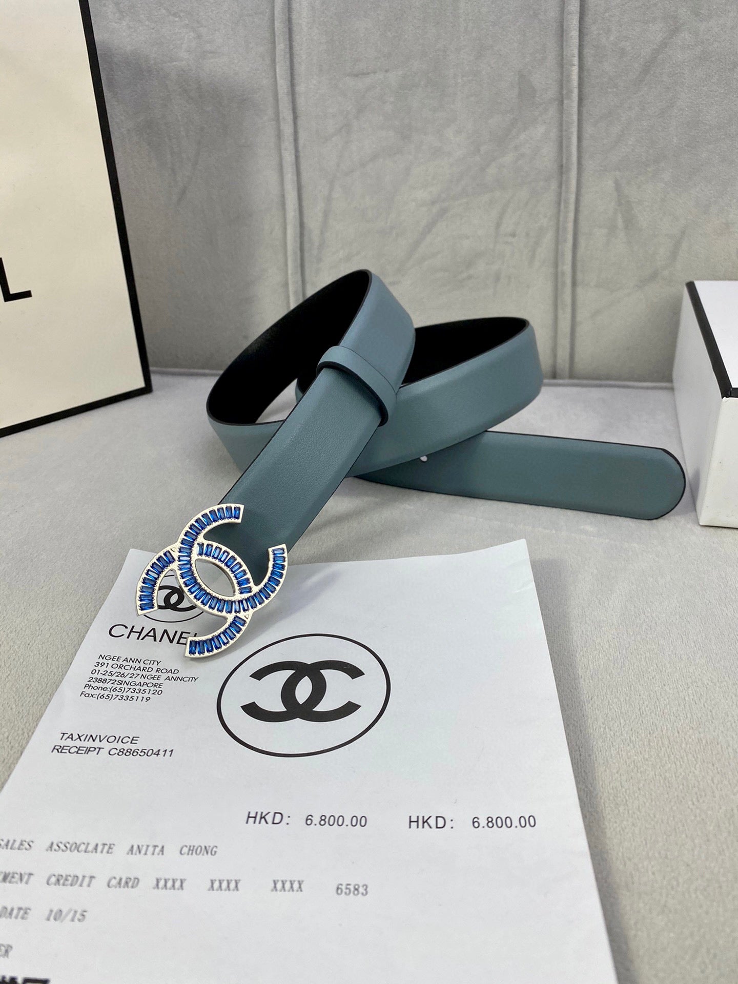 Chanel belt with light blue strap and CC logo buckle on box documents