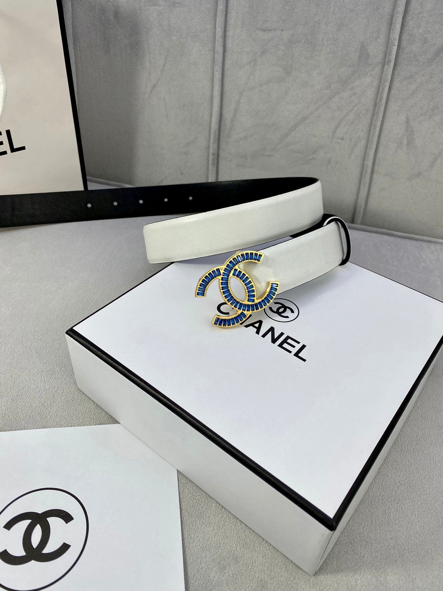 Chanel belt with light strap and blue jeweled CC buckle