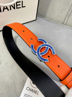Orange leather belt with blue CC buckle, angled side view