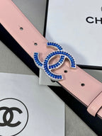 Close-up of pink leather belt with blue-and-gold CC logo buckle and holes