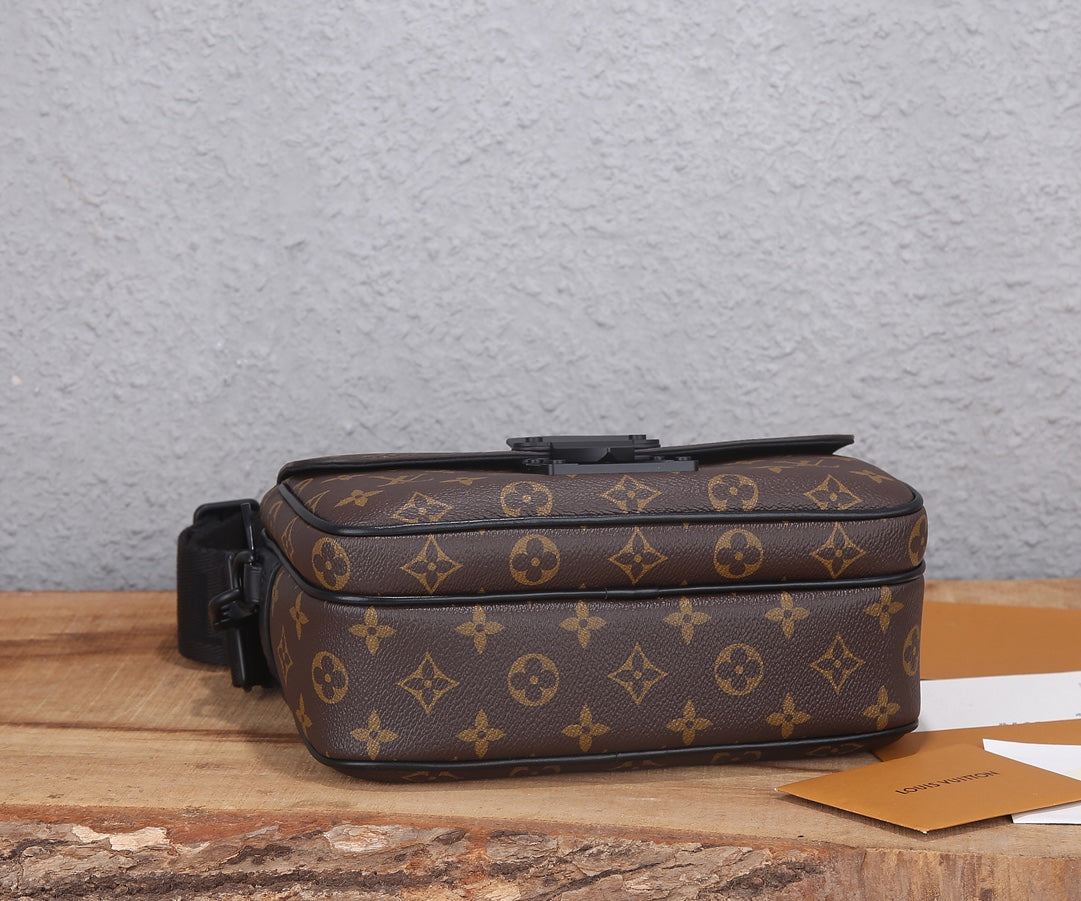 Louis Vuitton monogram crossbody bag side view with black strap and zipper pocket