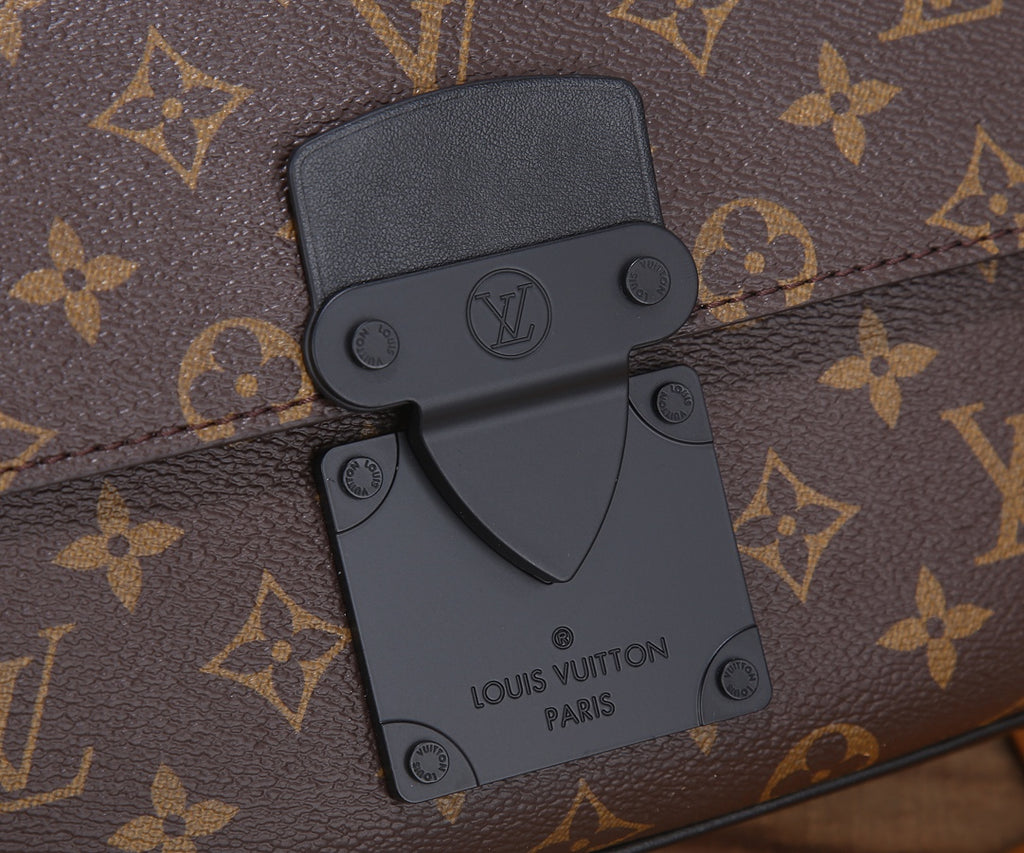 Louis Vuitton monogram bag front hardware and emblem detail on brown canvas