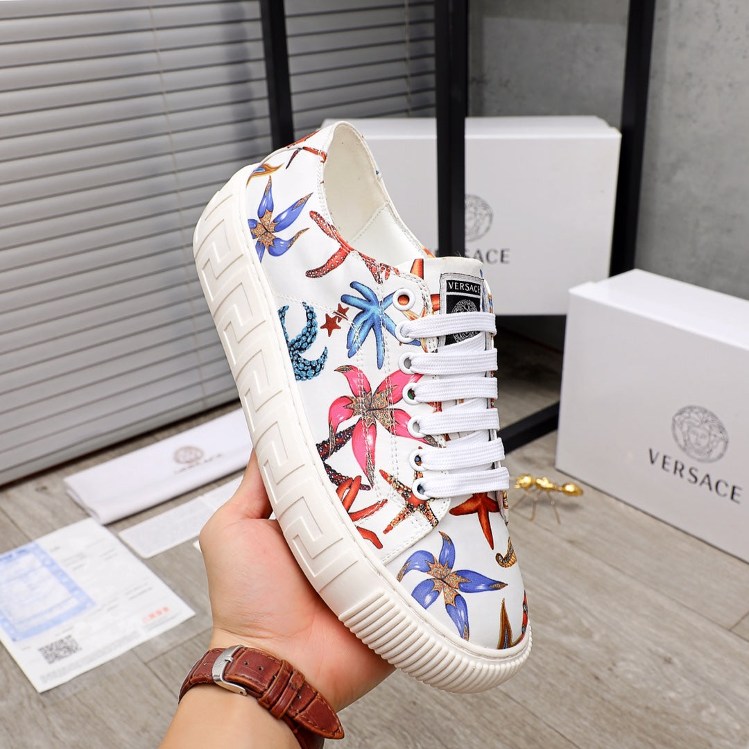 White low-top sneaker with colorful sea-print panels and white laces, chunky ridged sole.