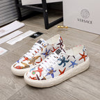 White low-top sneakers with multicolor ocean-print graphics, white laces and rubber sole.