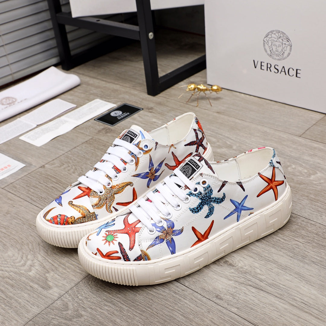 White low-top sneakers with multicolor ocean-print graphics, white laces and rubber sole.