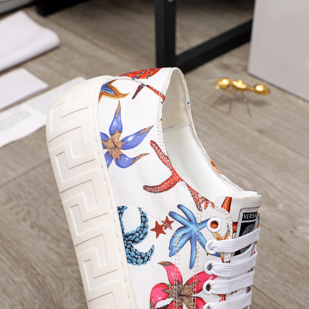 White low-top sneaker with colorful sea-life print and white laces, padded collar, chunky sole.
