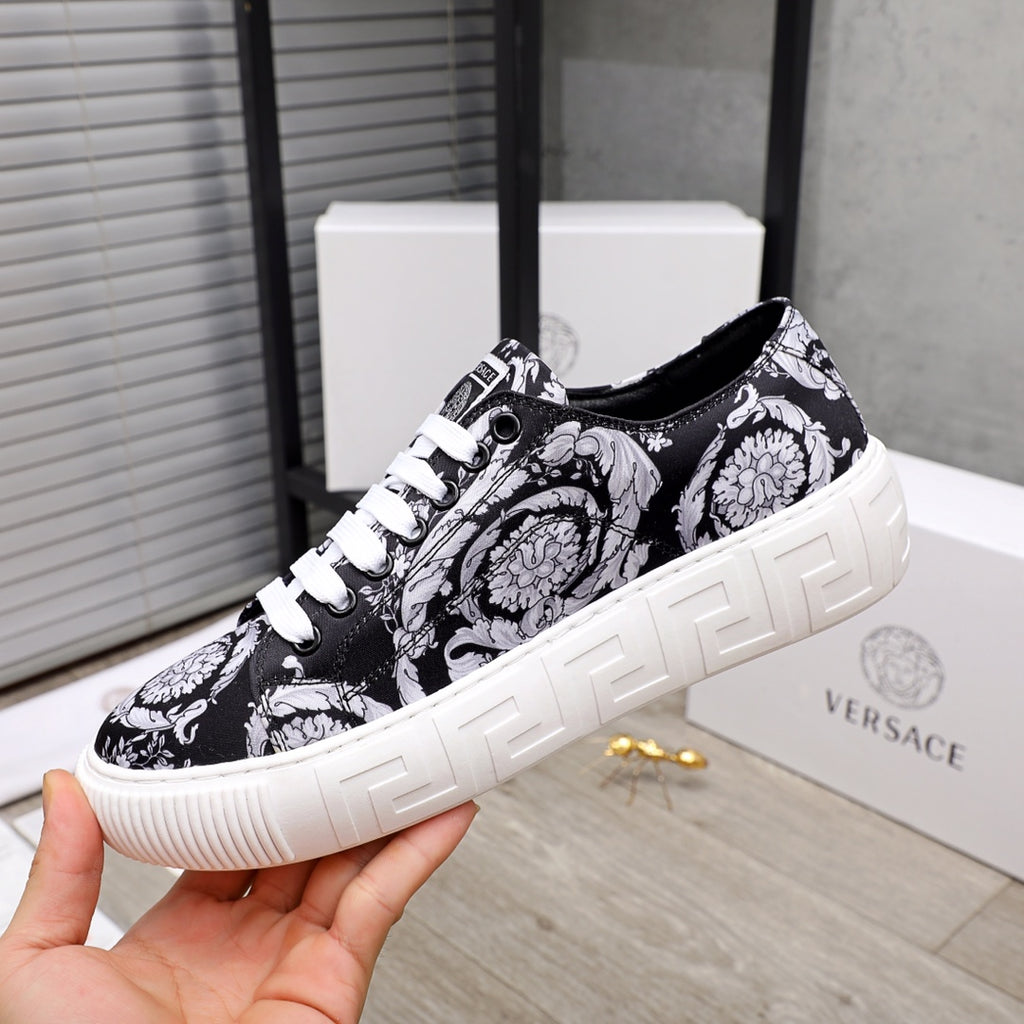 Versace luxury sneakers, front three-quarter view, black and white baroque print