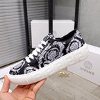 Versace luxury sneakers, front three-quarter view, black and white baroque print