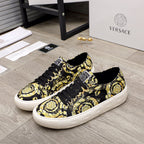 Versace luxury sneakers with black-and-yellow baroque print, black laces, white sole