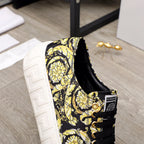 Versace luxury sneaker heel and side, black-and-yellow baroque print, black laces, white sole