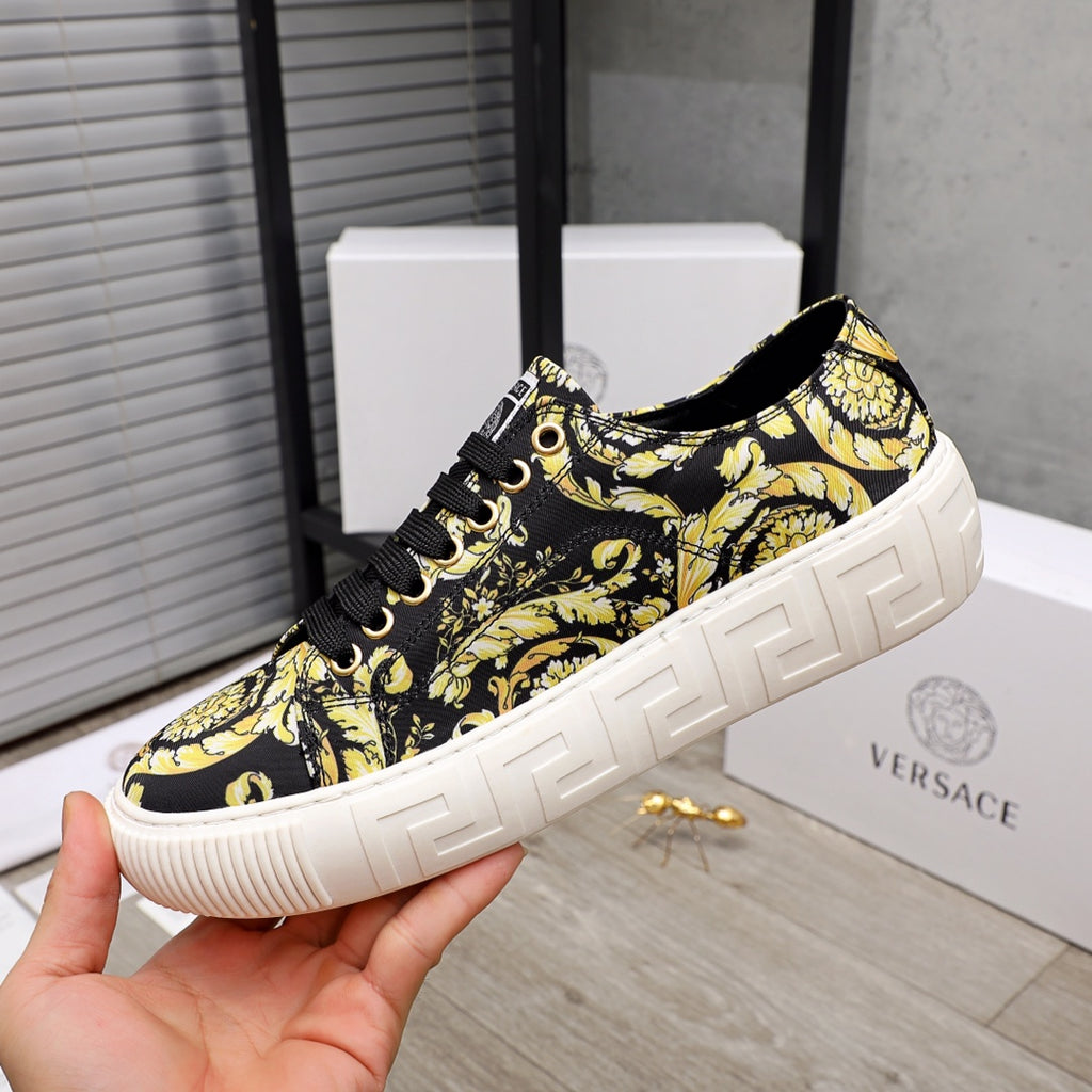 Versace luxury sneaker side view, black-and-yellow baroque pattern, black lace-up, white platform sole