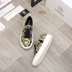 Versace luxury sneakers, one front and one side view; black-and-yellow baroque print, white sole