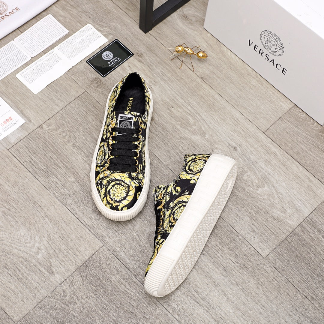 Versace luxury sneakers, one front and one side view; black-and-yellow baroque print, white sole