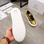 Versace luxury sneaker outsole, white textured rubber tread, sole held up for display