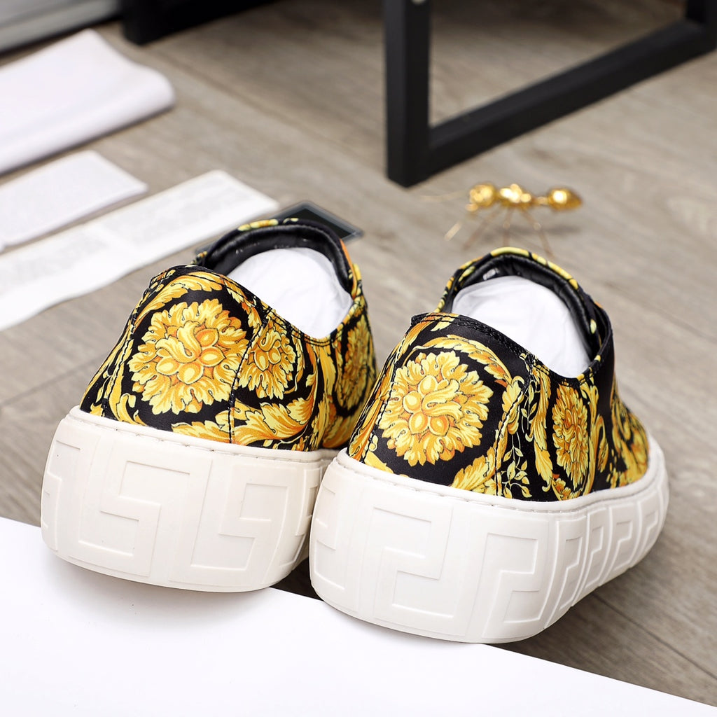 Versace luxury sneakers heel view, black and gold baroque print, thick white sole, lace-up