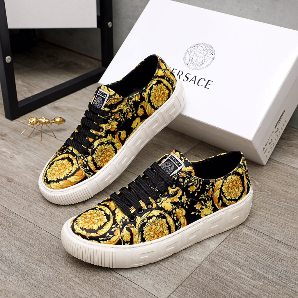 Versace luxury sneakers, side view in black and gold baroque print with white sole and laces