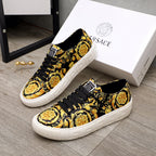 Versace luxury sneakers, side view in black and gold baroque print with white sole and laces