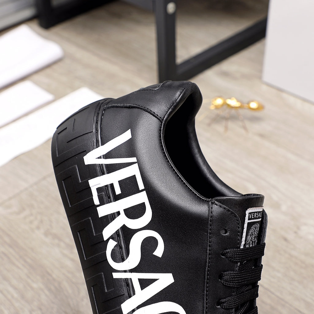Black sneaker showing side VERSACE lettering and lace-up upper