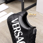 Black sneaker showing side VERSACE lettering and lace-up upper
