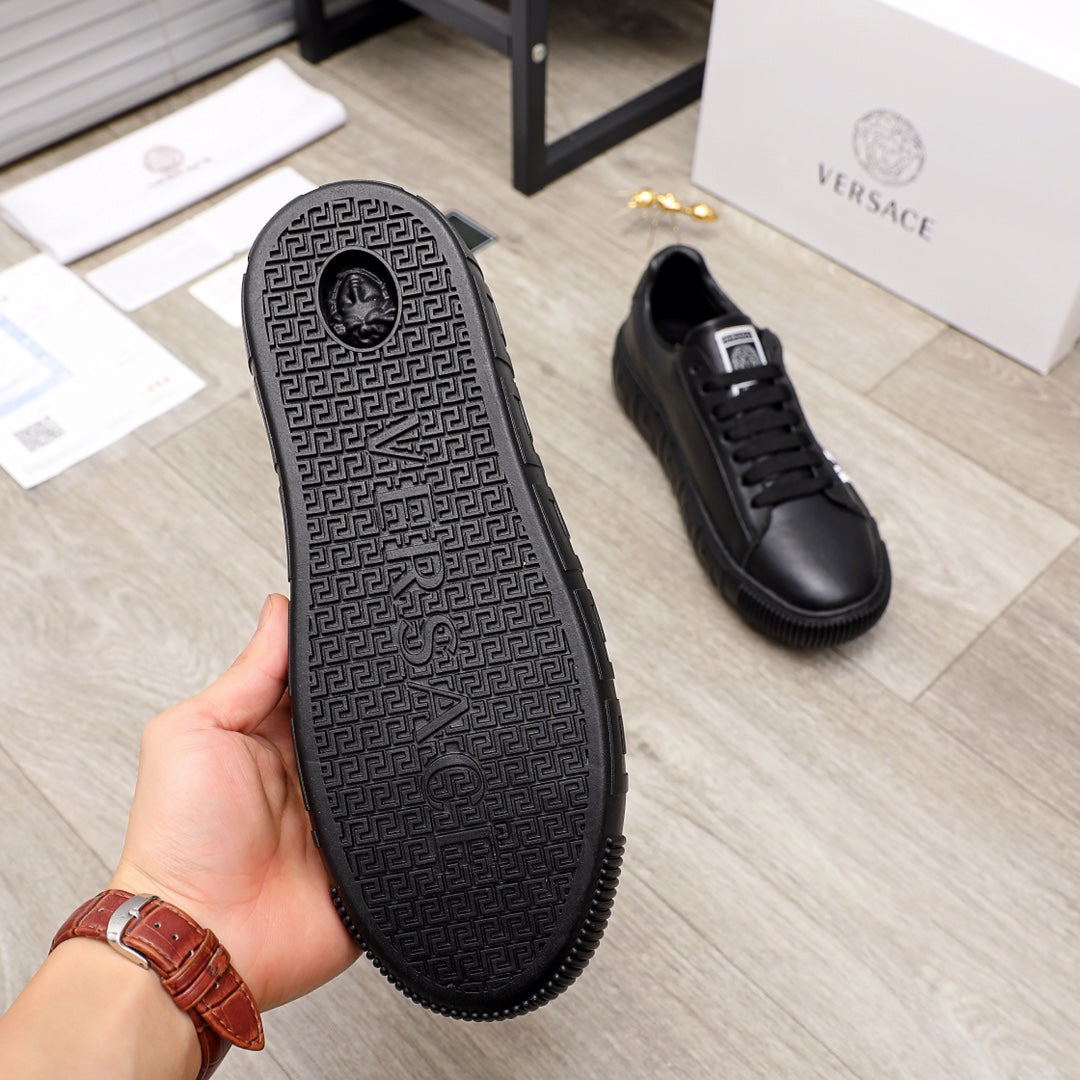 Black sneaker outsole with dark geometric pattern and raised tread edges