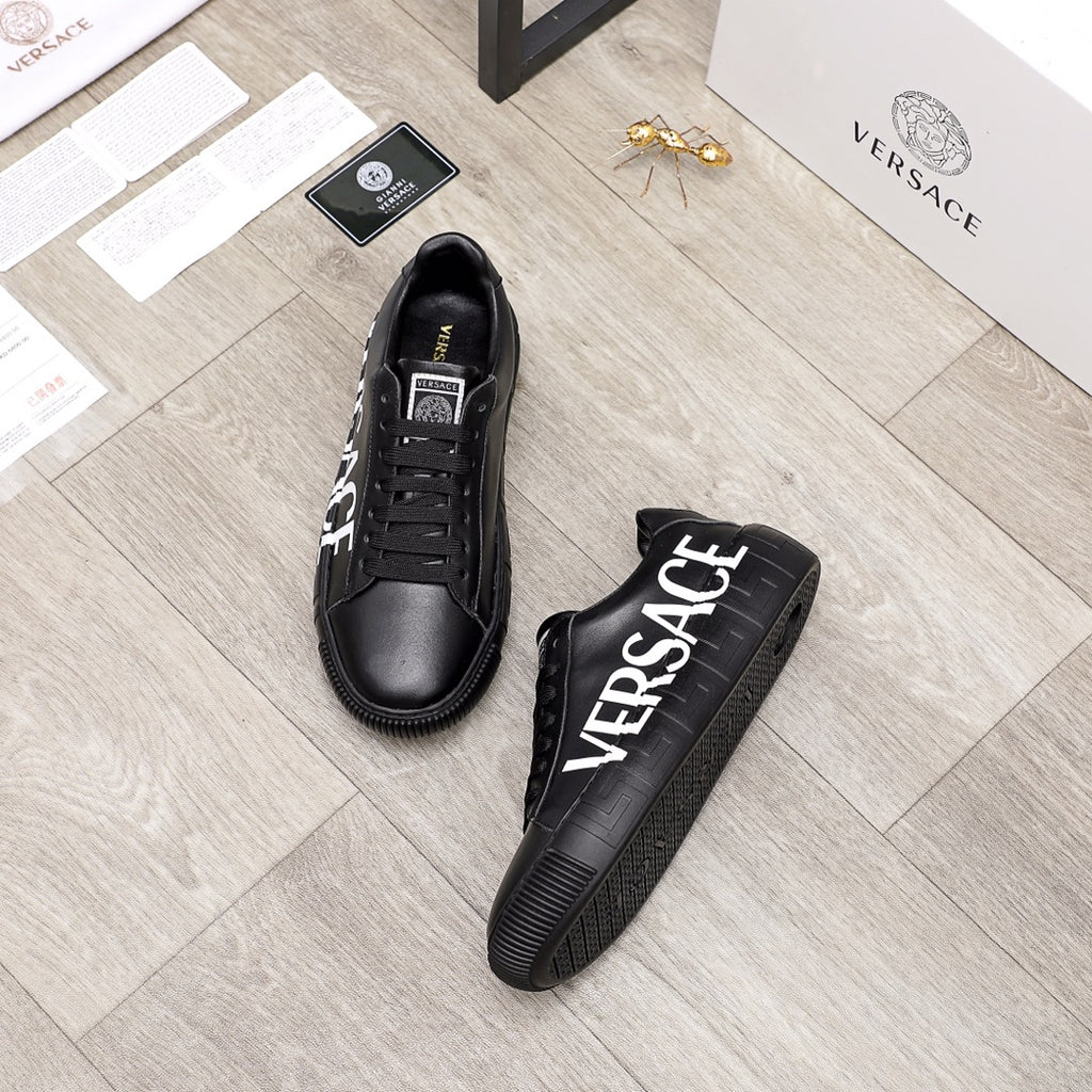 Black sneakers with white VERSACE logo on the side, shown with pair view