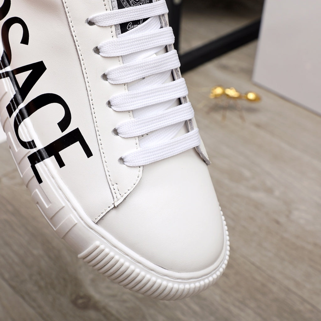 White Versace sneakers close-up with black logo on side and white lace-up