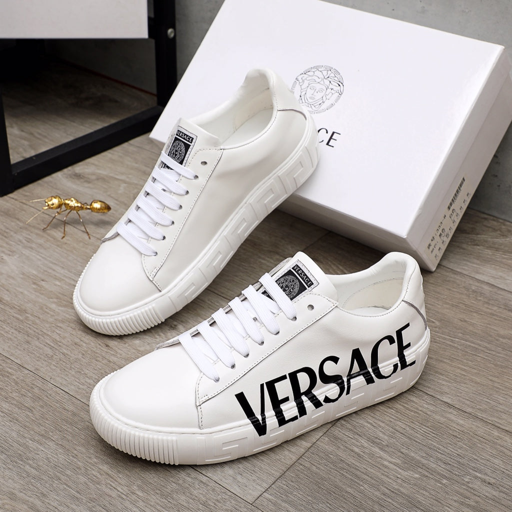 White Versace sneakers with black VERSACE logo, lace-up design, ridged sole