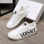 White Versace sneakers with black VERSACE logo, lace-up design, ridged sole