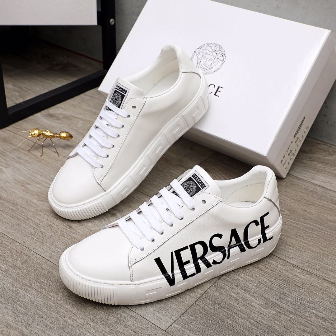 White Versace sneakers with black VERSACE logo, lace-up design, ridged sole