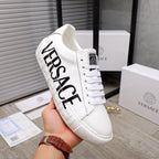 White Versace sneakers with large black VERSACE lettering on side, lace-up