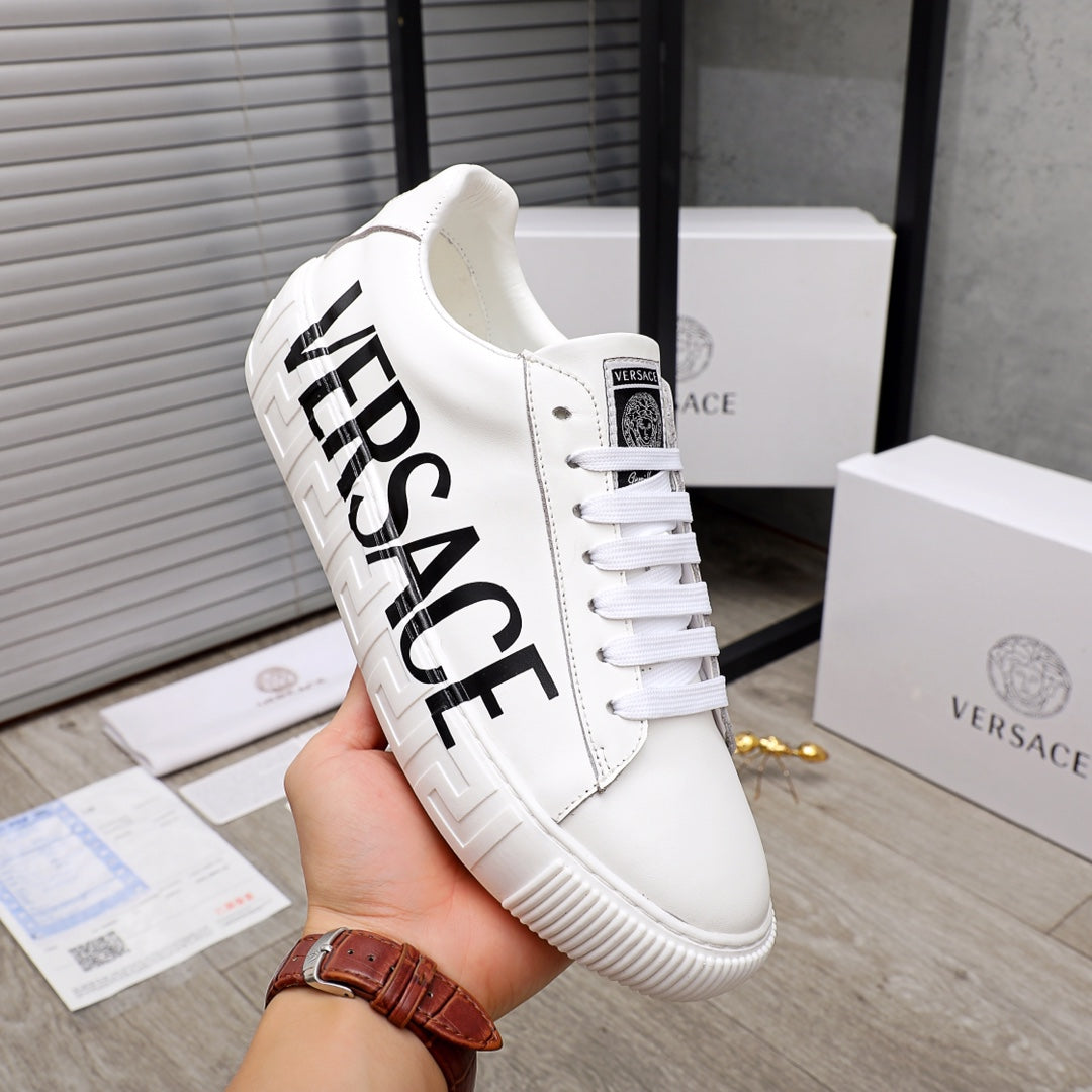 White Versace sneakers with large black VERSACE lettering on side, lace-up