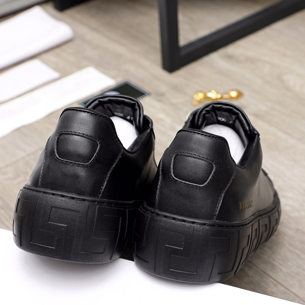 Versace black leather sneakers, back view with padded heel and ribbed sole