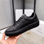 Versace black leather sneakers, front side view with lace-up and sculpted sole