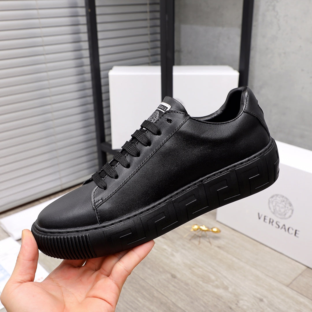 Versace black leather sneakers, front side view with lace-up and sculpted sole