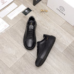Versace black leather sneakers, pair view with lace-up and low-profile sole