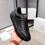 Versace black leather sneakers, side view with lace-up closure and thick sole