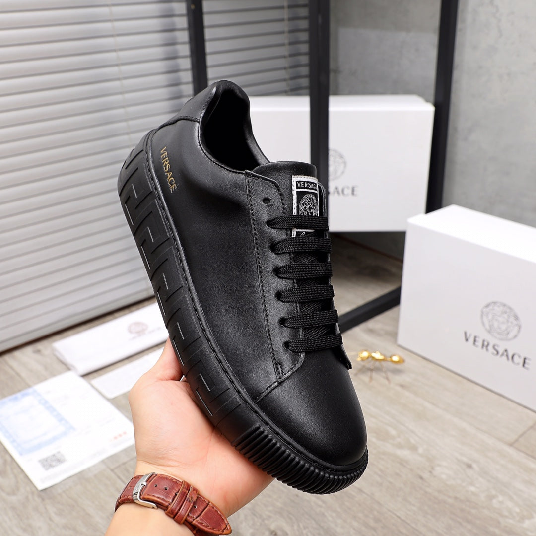 Versace black leather sneakers, side view with lace-up closure and thick sole