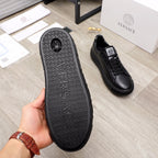 Versace black leather sneakers, outsole view with textured pattern and grip edge