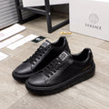 Versace black leather sneakers with lace-up front and rubber tread sole