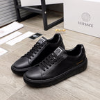 Versace black leather sneakers with lace-up front and rubber tread sole