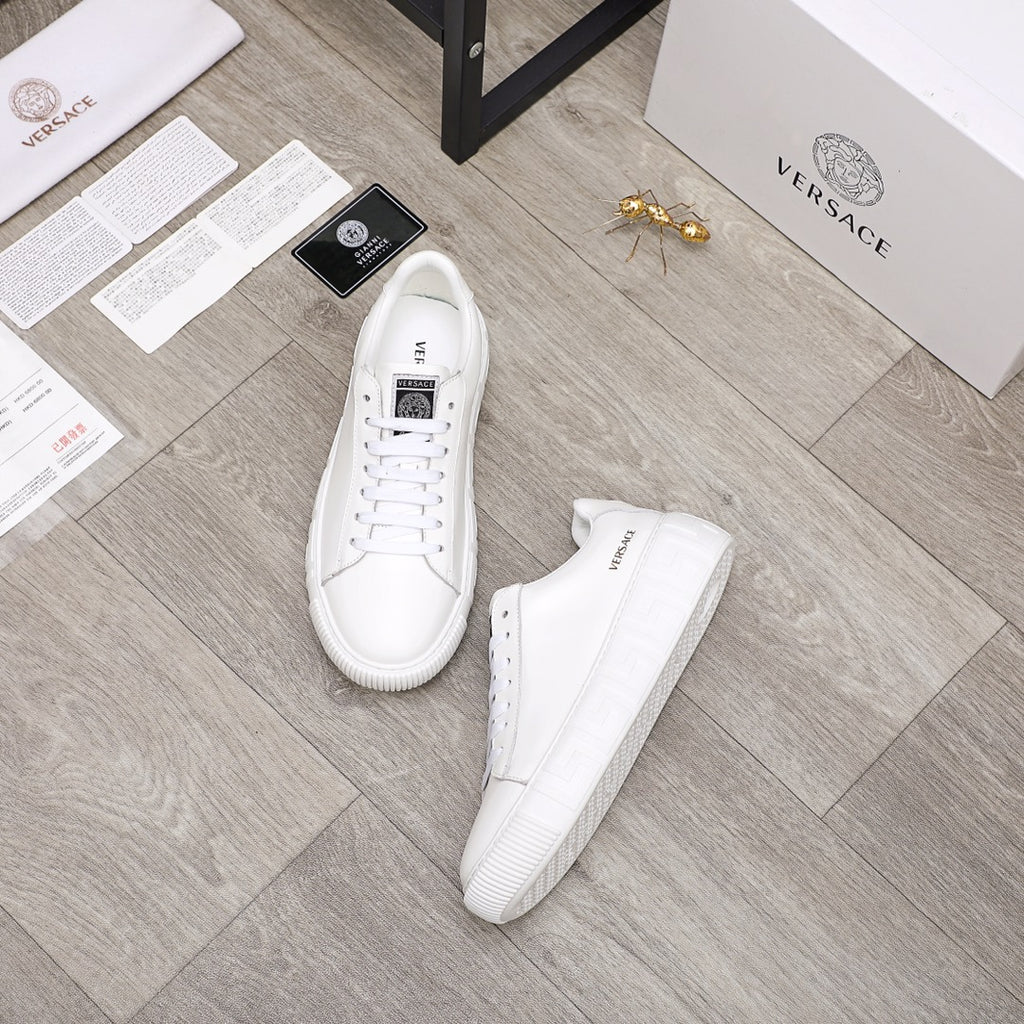 Versace white lace-up sneakers with low profile and cushioned outsole, top and side view